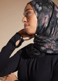 Black colour. Cut in 100% cotton jersey with a fitted bodice & voluminous drop. Styling details include a round neckline with subtle pleats. Features button fastenings on the back & sleeve cuffs.