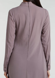 This Box Pleat Abaya Taupe features a fluid, A-line cut with a neat box pleat that runs from the high neck line to the bottom of the garment. The abaya is lightweight and airy, and a slip is necessary to wear underneath. 