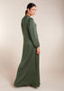 Crafted from smooth, wrinkle-resistant fabric, the Crinkled Abaya Sage boasts a graceful A-line silhouette that complements all body types. Its rich Bottle Green color exudes sophistication, making it a perfect addition to your wardrobe.