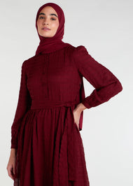 This Crinkled Chiffon Maxi Burgundy is fully lined, lightweight, and airy. It also has the option of a belt and pockets for added convenience. The chiffon material adds texture.