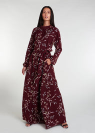 This floral maxi dress in maroon boasts a raised mandarin neck line and subtle pleating for a sophisticated touch. The flowing silhouette can be cinched at the waist, and discreet side pockets offer practicality. Made from lightweight, airy fabric for a comfortable fit.