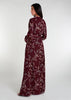 This floral maxi dress in maroon boasts a raised mandarin neck line and subtle pleating for a sophisticated touch. The flowing silhouette can be cinched at the waist, and discreet side pockets offer practicality. Made from lightweight, airy fabric for a comfortable fit.