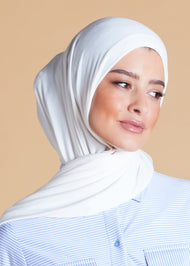 White premium jersey hijab. Effortless to style and incredibly comfortable to wear, with a subtle sheen. The medium-thick weight is soft, breathable, fully opaque and durable. Jersey works well in all climates, can be worn without an under scarf or pins, and makes a great option for working out.