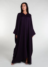 Our V Neck Kaftan in an intense aubergine hue features a front rise and cascading sides, creating a breezy and flowy aesthetic. This versatile piece is ideal for any summer occasion and paired with statement jewelry, it will elevate your overall look. 